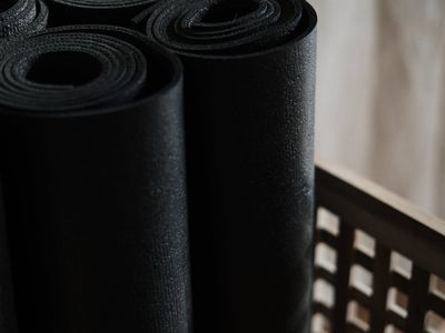 Close-up of a rolled green yoga mat on floor
