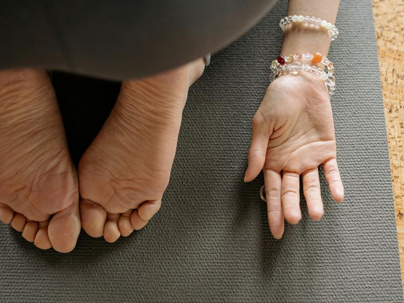 Detailed close-up of hands and yoga mat setup