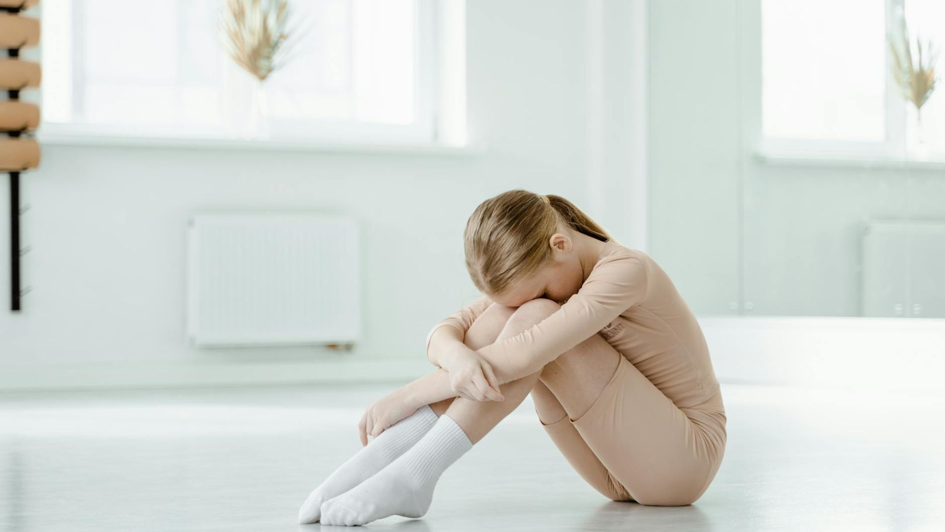 Person practicing mindfulness exercises in a bright minimalist room